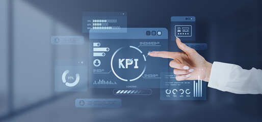 Hand pointing at KPI dashboard on screen.