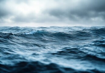 Serene Ocean Waves Under Dramatic Cloudy Sky Captured at Dusk, Showcasing the Beauty of Nature's Powerful Waters in a Tranquil Moment
