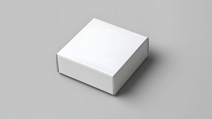 Plain white box on a minimalist gray surface, ideal for packaging or product presentation