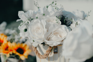 Beautiful White Roses in Decorative Bucket Surrounded by Sunflowers Perfect for Event Decor or Botanical Arrangements