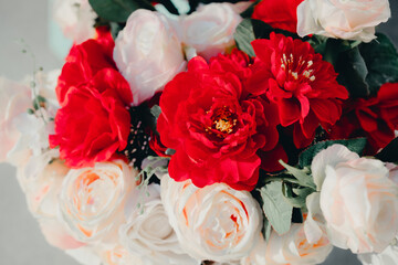 Beautiful arrangement of vibrant red and soft white roses with delicate accents in a bright floral display for decor