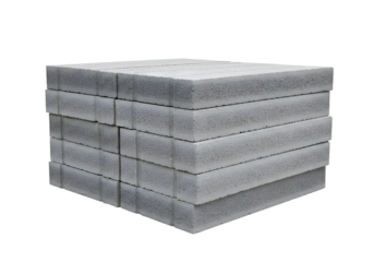 Stack of lightweight concrete blocks arranged neatly on a white background, showcasing construction material for various projects