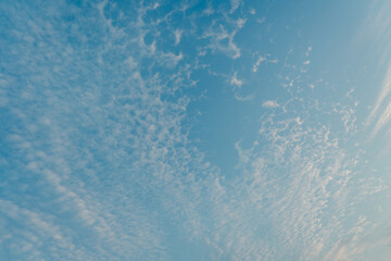 Serene Skies with Wispy Clouds and Bright Blue Background Captured on a Clear Day in Nature's Tranquil Environment