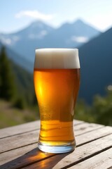 A glass of cold beer on wood table with blurred mountain background. Beer mug. Refreshment and party concept. Alcohol beverage menu