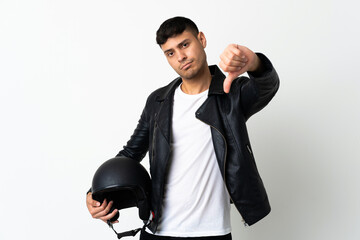 Man with a motorcycle helmet isolated on white background showing thumb down with negative...