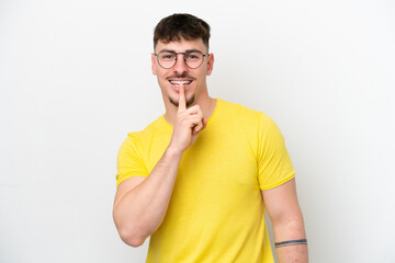 Young caucasian handsome man isolated on white background showing a sign of silence gesture putting...
