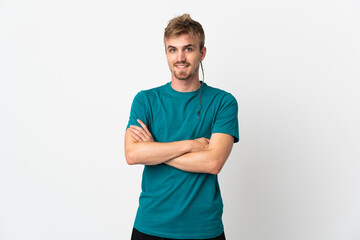 Young handsome man isolated on white background keeping the arms crossed in frontal position