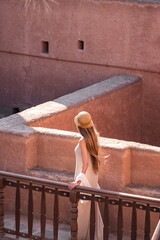 Tourist woman walking in jabrin castle, exploring ancient oman architecture