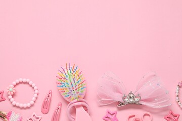 Cute hair accessories on pink background, flat lay. Space for text