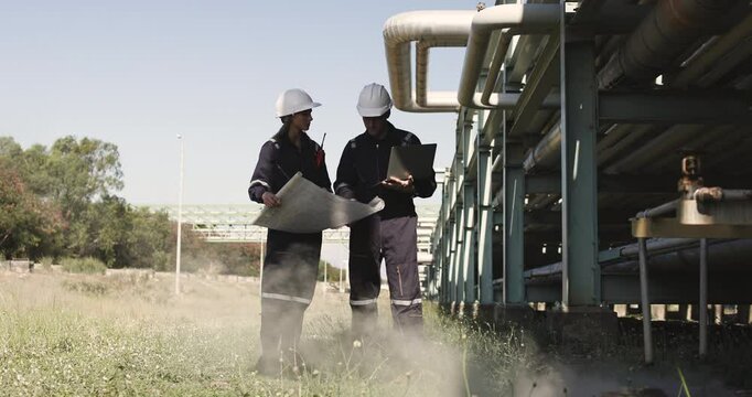 Two mechanical engineers performed detailed inspections and maintenance on a pipeline system that is meticulously designed for the transportation of oil, natural gas, and fuel within an industrial fac