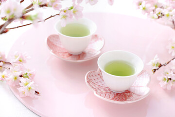 Two cups of  japanese green tea with three-colored dumplings, Sakura flowers  お茶と三色団子　さくらの花