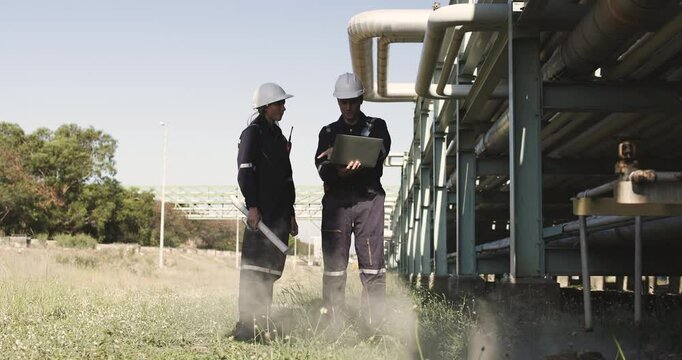 Two mechanical engineers performed detailed inspections and maintenance on a pipeline system that is meticulously designed for the transportation of oil, natural gas, and fuel within an industrial fac