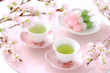 Two cups of  japanese green tea with three-colored dumplings, Sakura flowers  お茶と三色団子　さくらの花