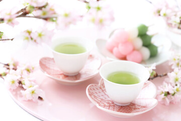 Two cups of  japanese green tea with three-colored dumplings, Sakura flowers  お茶と三色団子　さくらの花