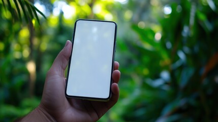 Hand holding phone in a garden