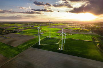 Sunset over a windmill farm from a drone © ArtemisStudio