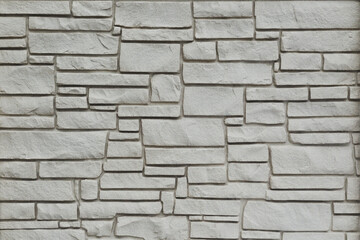 White brick wall, rough texture with soft shadows.