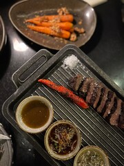 Grilled Wagyu Beef Steak with Roasted Carrot, Gourmet Dipping Sauces, Coarse Sea Salt, Fine Dining Plating, Black Stone Grill