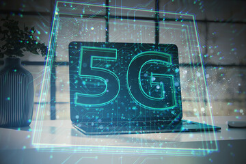 Futuristic 5G technology concept with glowing digital elements over laptop on desk.