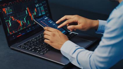 Analyzing stock market data on laptop and smartphone