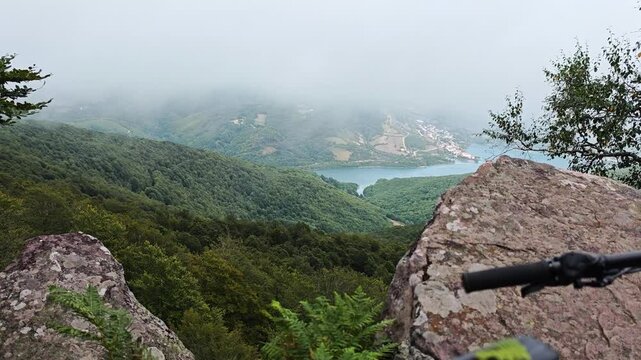 Majestic sunrise at the viewpoint of Burdindogi, Eugi, Navarra: Great forest and mountains a lake and rolling fog covering everything quickly. Concept: mountain bike routes nature and inspiration.