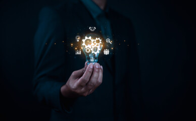 Technology and business growth, while the lightbulbs over his head represent creative ideas and visions for the future and the research and promotion of new solutions in the technology industry.