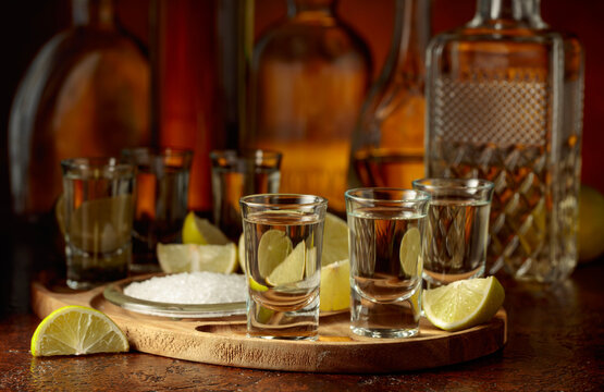 Gold tequila with salt and lime slices.