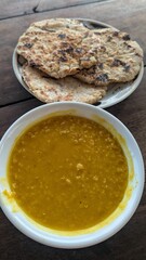 Birds eye view of traditional Sri Lankan red lentil dahl curry and coconut rotis for breakfast