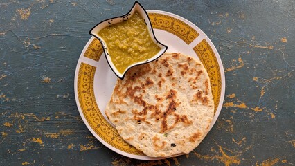 Delicious Sri Lankan lentil dahl and coconut roti bread cuisine on a decorative plate