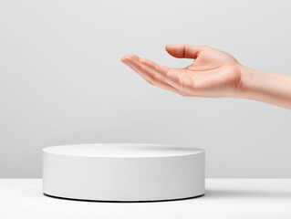 hand hovers over sleek, white, circular device, suggesting touchless interaction