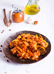 Stewed or braised cabbage served on dark plate