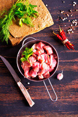 bowl of raw meat on wooden table,