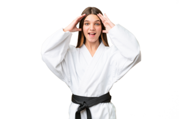 Teenager girl doing karate over isolated chroma key background with surprise expression