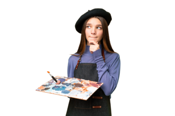 Young artist man holding a palette over isolated chroma key background having doubts and thinking