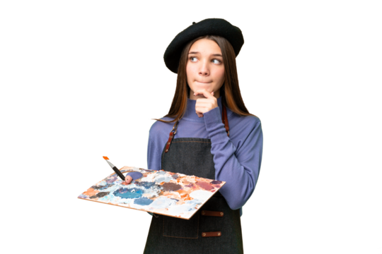 Young artist man holding a palette over isolated chroma key background having doubts and thinking