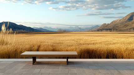 serene countryside view featuring wooden bench overlooking golden fields and mountains
