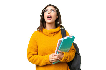 Young student woman over isolated chroma key background looking up and with surprised expression