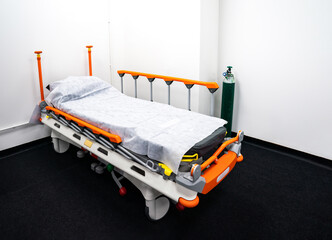 Camp bed with orange bed rails for side effect of Covid-19 vaccinated patient, it is able to be...