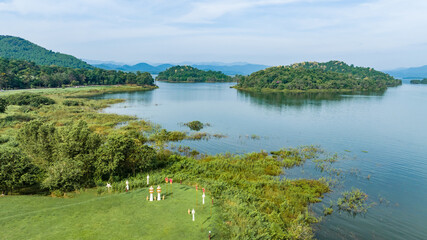 Obraz premium Kaeng Krachan dam with lake view and many green moutain, blue sky background. Kaeng Krachan Dam national park, Phetchaburi province, Thailand in aerial view from drone.