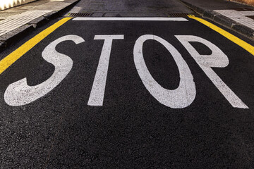 STOP sign at the intersection of the city streets. Traffic rules. 