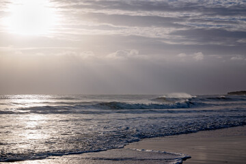 Early morning sunrise Burnett Heads Beach Queensland, atmospheric light rays and ocean waves,...