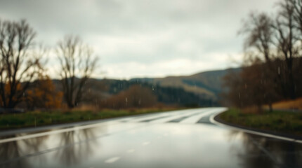 Abstract blur of a wet road surrounded by trees with a gloomy atmosphere, perfect for moody or introspective themes.