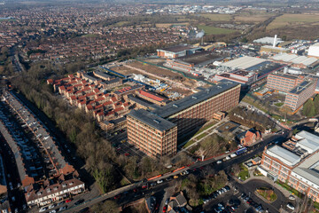 Fototapeta premium Aerial drone photo of the city of York in North Yorkshire, England showing the large Nestle chocolate factory in the city showing the large building surrounded by houses and homes in the winter time
