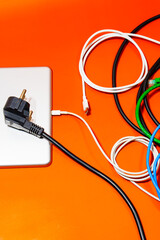 Electronic device with a bunch of colorful wires on top of an orange table. 