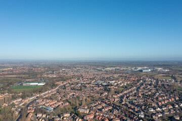 Aerial drone photo of the city of York in North Yorkshire England showing a birds eye view of the British town and rows of houses and large suburban housing estates taken in the winter time
