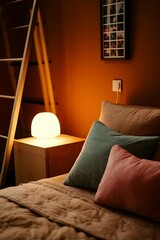 Interior of cozy bedroom with pillows on bed, nightstand, lamp, picture frame and rack