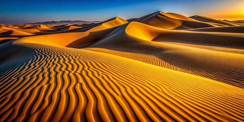 Naklejka premium Golden Desert Sunrise: Macro Photography of Textured Dunes with Long Shadows