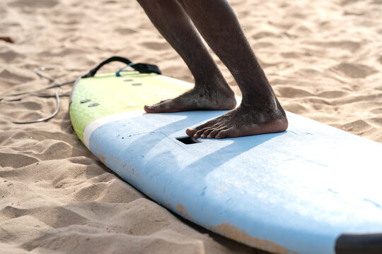 An example position of Asian professional feet on a surfboard in surfing board lesson study and training by the teacher.