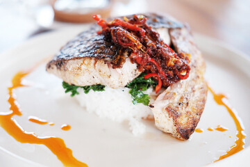 Traditional food deep fried fish Seabass with chilli sauce with rice on white dish

