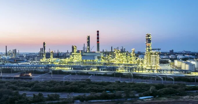 circling aerial time lapse of a large refinery in nightfall, beautiful industry landscape of the petrochemical aromatic hydrocarbons project 